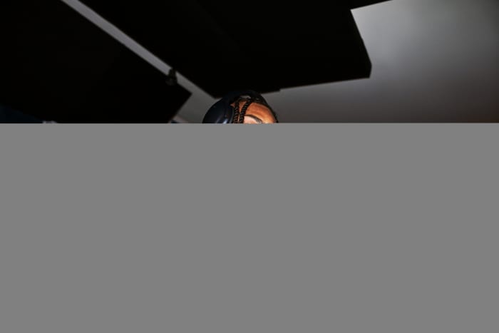 Justin Jefferson poses with a purple and white Under Armour shoe.